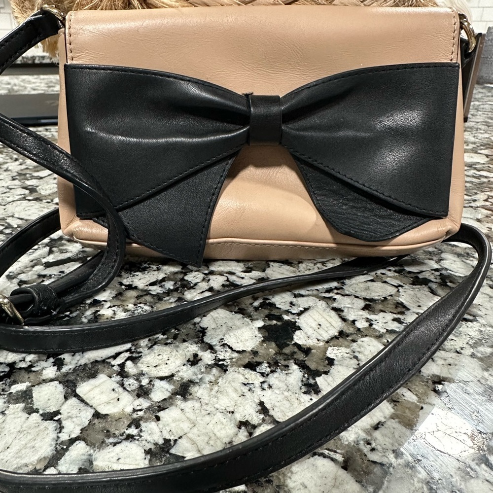 Kate Spade chic tan purse with black bow